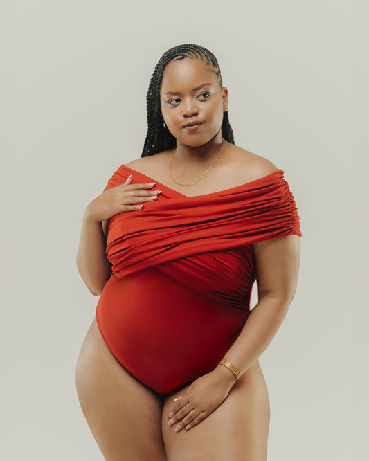 A model wearing a Ruched red bodysuit front view