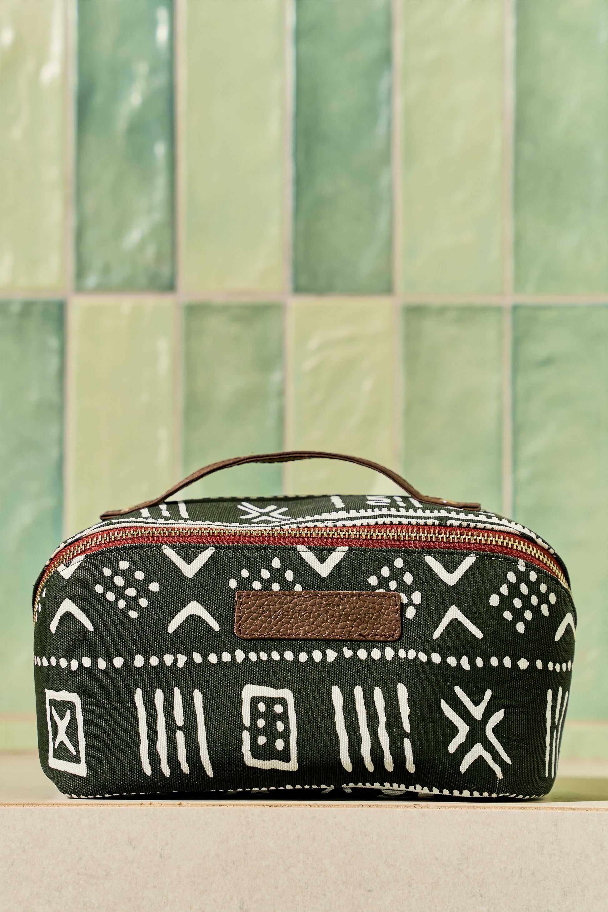 Zola toiletry bag in mud cloth print, front view.
