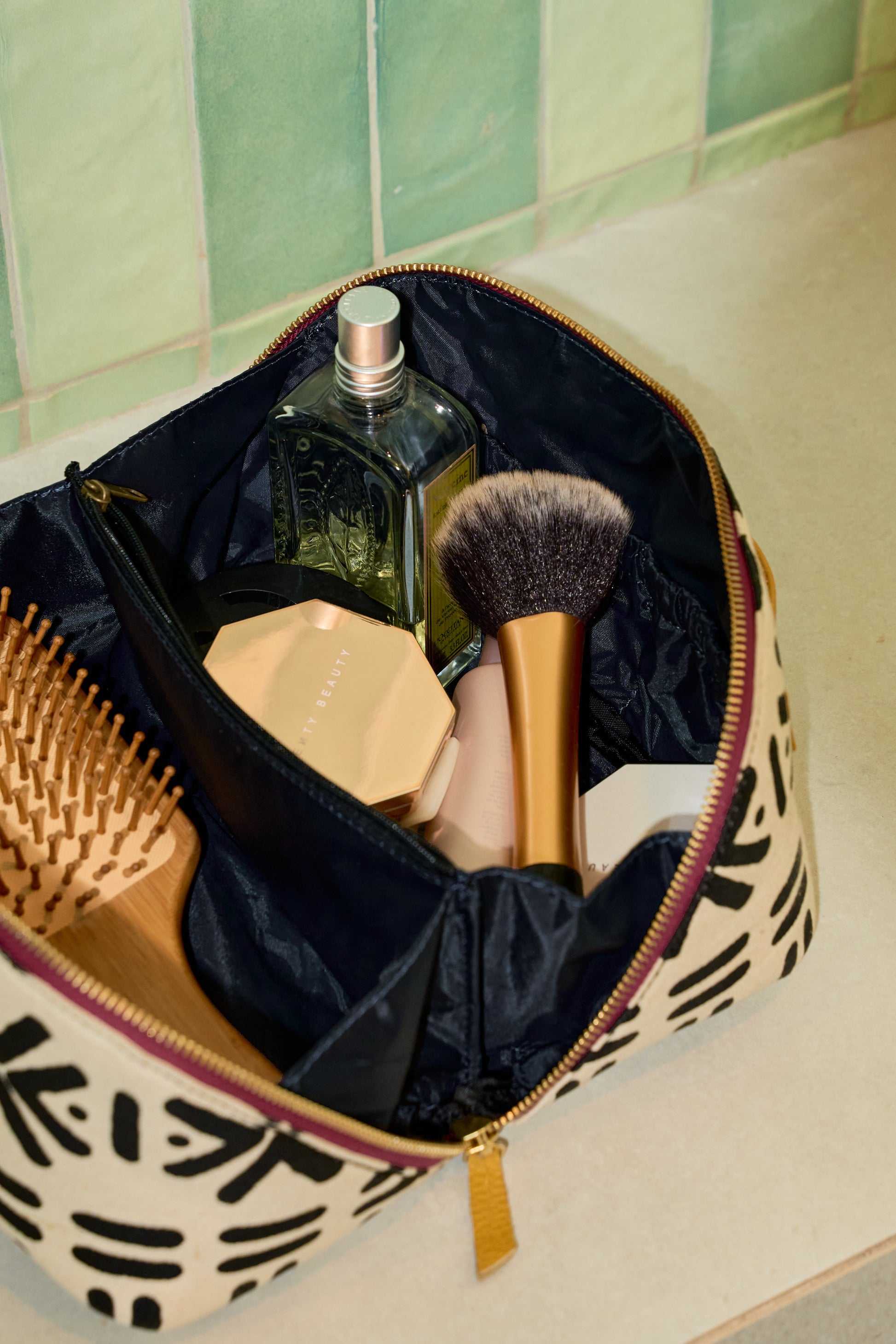 Zola toiletry bag open to reveal waterproof navy lining and four interior pocket sleeves.